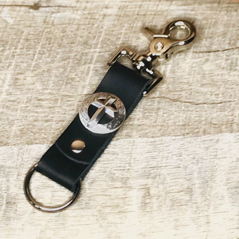 Silver toned cross on black leather keychain with trigger snap and keychain